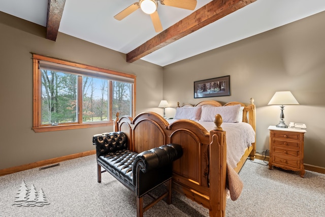 carpeted bedroom featuring beam ceiling, visible vents, ceiling fan, and baseboards