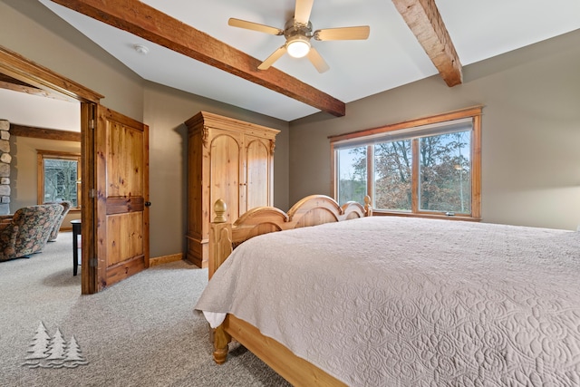 bedroom featuring beam ceiling, a ceiling fan, baseboards, and carpet floors