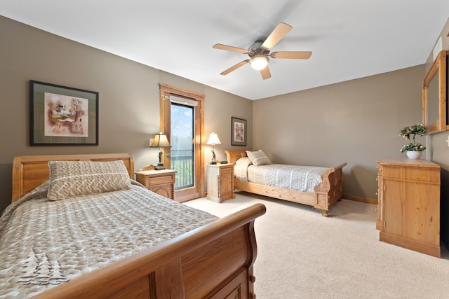 bedroom with light colored carpet, baseboards, and ceiling fan