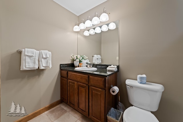 half bath featuring tile patterned floors, toilet, vanity, and baseboards