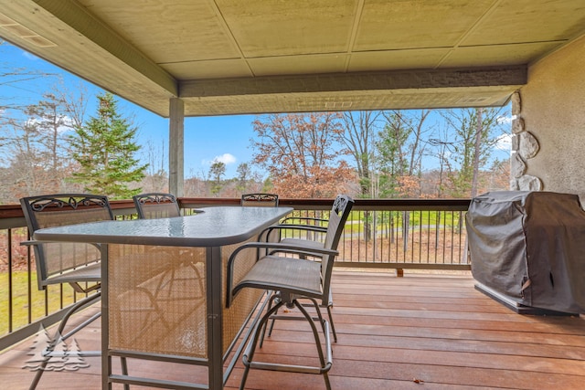 deck featuring grilling area and outdoor dining area