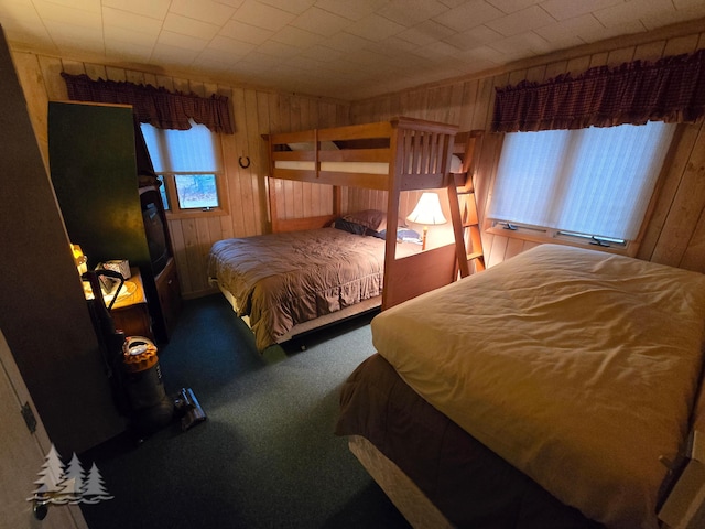 carpeted bedroom with wooden walls