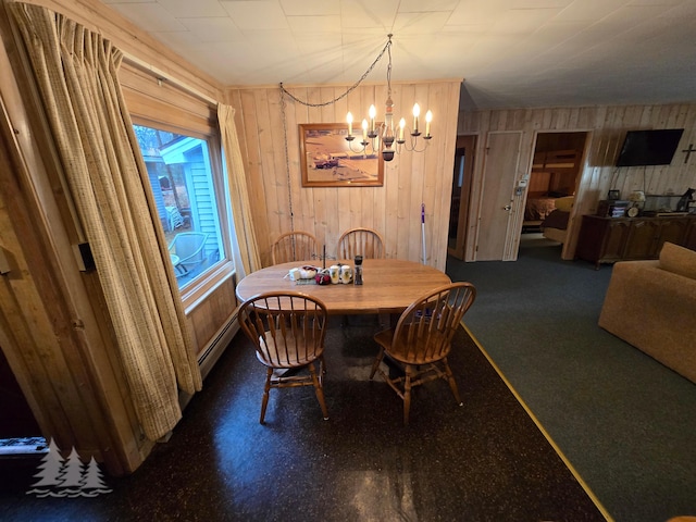 dining area featuring a notable chandelier and a baseboard radiator