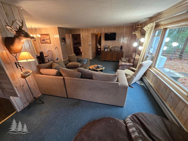 carpeted living room with a baseboard heating unit and wooden walls