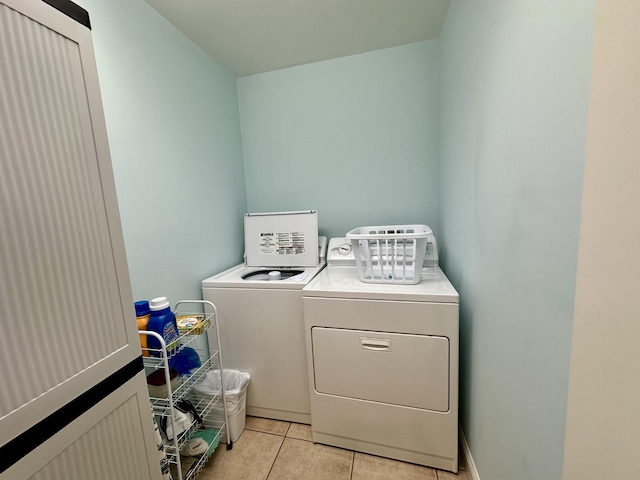 washroom featuring laundry area, light tile patterned flooring, and separate washer and dryer