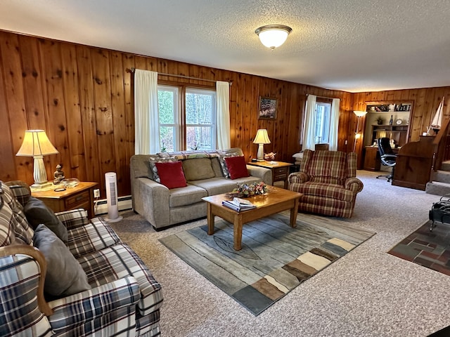 carpeted living room featuring wooden walls and a textured ceiling
