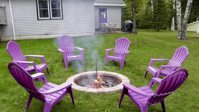 view of yard with an outdoor fire pit