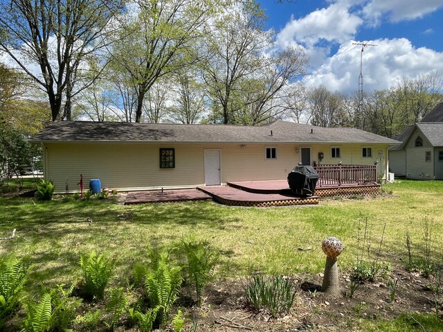 991 W Higgins Lake Dr, Roscommon, MI 48653 - rear view of property featuring a deck and a yard