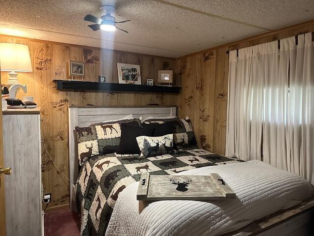 bedroom with wood walls and a textured ceiling