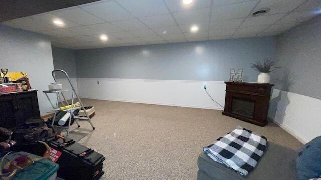 interior space with recessed lighting, a fireplace, carpet floors, and a paneled ceiling