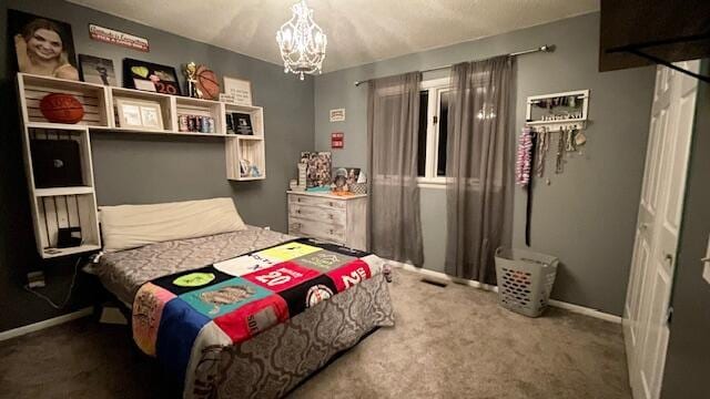 bedroom featuring a notable chandelier, baseboards, and carpet floors