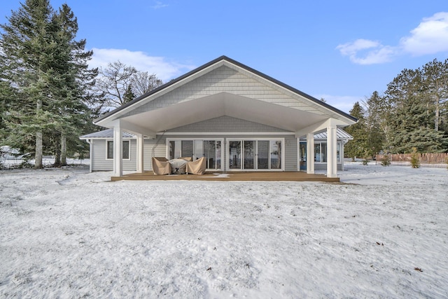 snow covered property with a wooden deck