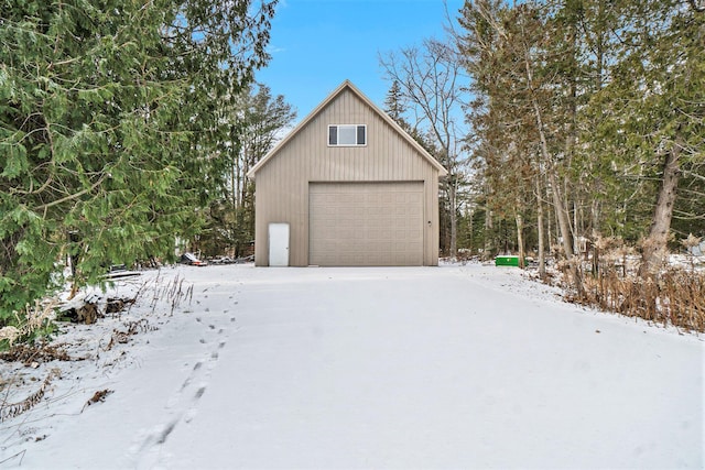 snow covered garage with a garage