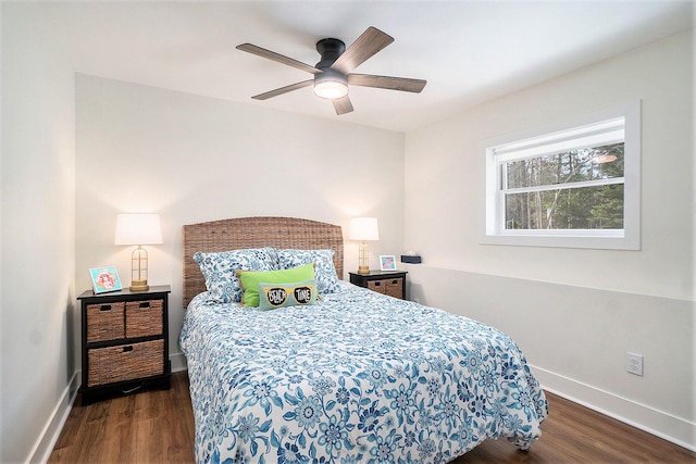 bedroom with ceiling fan, baseboards, and dark wood-style floors