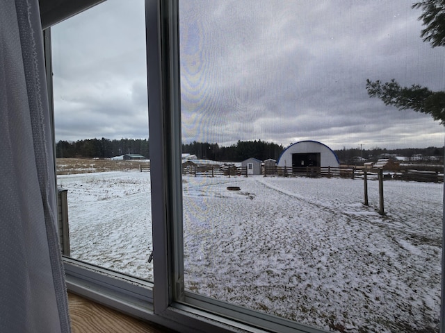 yard covered in snow with an outbuilding and a pole building