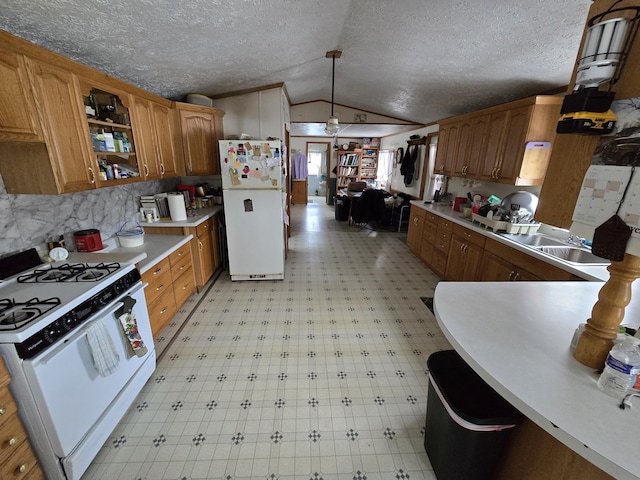 kitchen featuring white appliances, light floors, open shelves, a sink, and vaulted ceiling