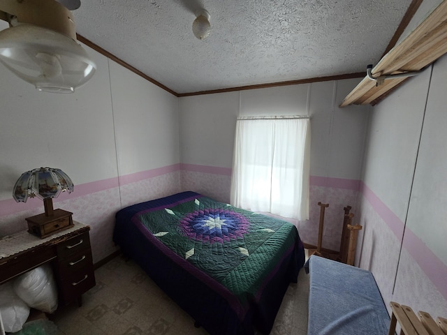 bedroom with tile patterned floors, wainscoting, a textured ceiling, and ornamental molding