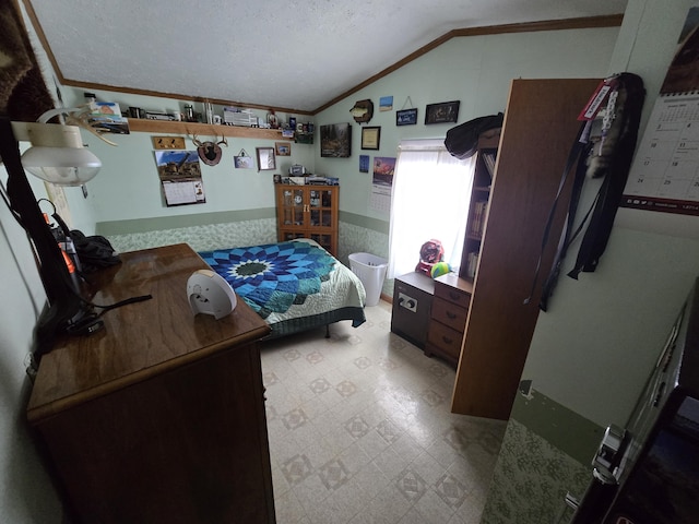 bedroom with tile patterned floors, a textured ceiling, wainscoting, crown molding, and vaulted ceiling