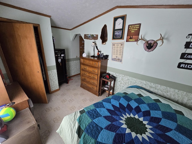 bedroom with a wainscoted wall, a textured ceiling, crown molding, lofted ceiling, and light floors