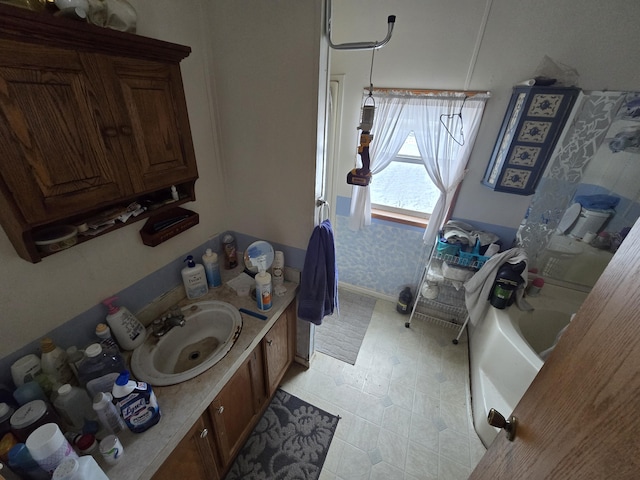 bathroom featuring a tub to relax in and vanity