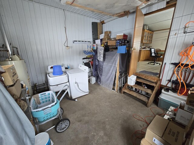 basement with water heater, washer / dryer, and metal wall