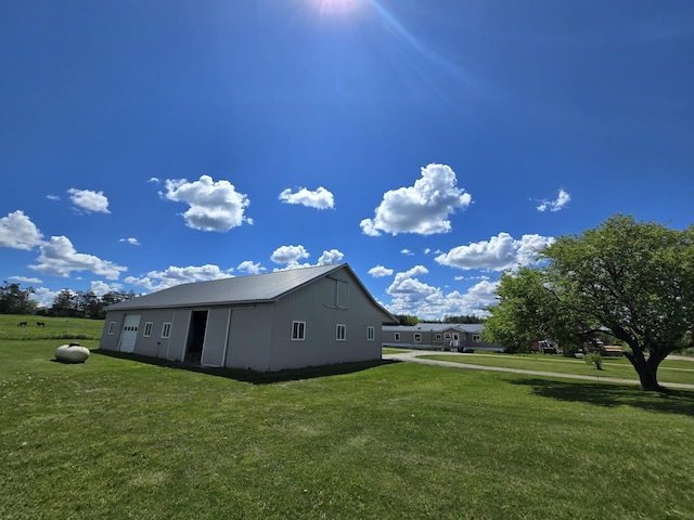 440 N Galbraith Rd, Mio, MI 48647 - view of side of home with a lawn, metal roof, and an outbuilding