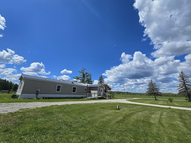 440 N Galbraith Rd, Mio, MI 48647 - view of side of home featuring a yard and metal roof
