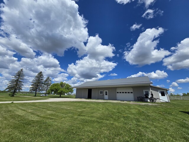 440 N Galbraith Rd, Mio, MI 48647 - view of front of home featuring dirt driveway, metal roof, and an attached garage