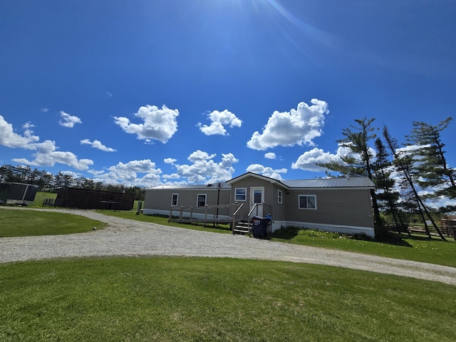 440 N Galbraith Rd, Mio, MI 48647 - manufactured / mobile home featuring a front yard, metal roof, and driveway