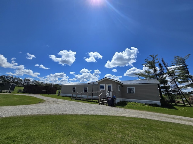 440 N Galbraith Rd, Mio, MI 48647 - manufactured / mobile home with a front lawn, metal roof, and gravel driveway