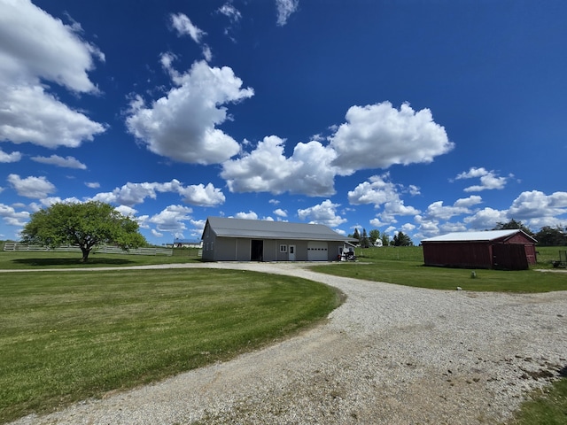 440 N Galbraith Rd, Mio, MI 48647 - ranch-style house with an attached garage, a front lawn, gravel driveway, and an outbuilding