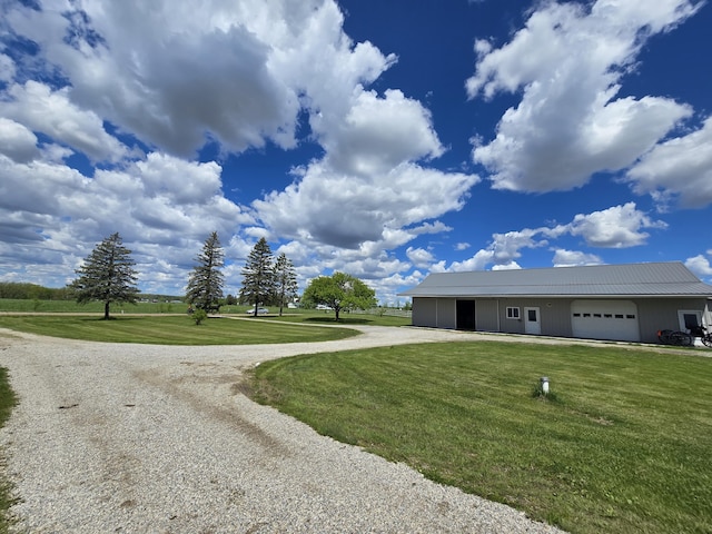 440 N Galbraith Rd, Mio, MI 48647 - view of front of house with gravel driveway, a front lawn, a garage, and metal roof