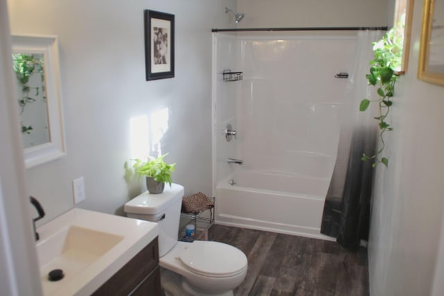 bathroom featuring toilet, shower / bath combo with shower curtain, vanity, and wood finished floors