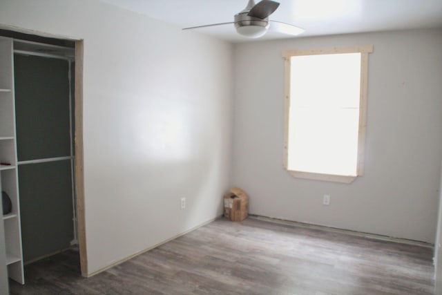 unfurnished bedroom with ceiling fan and wood finished floors