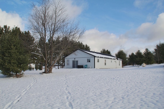 yard layered in snow featuring an outbuilding and an outdoor structure