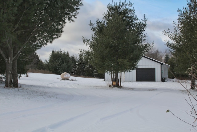 exterior space with a detached garage and an outbuilding