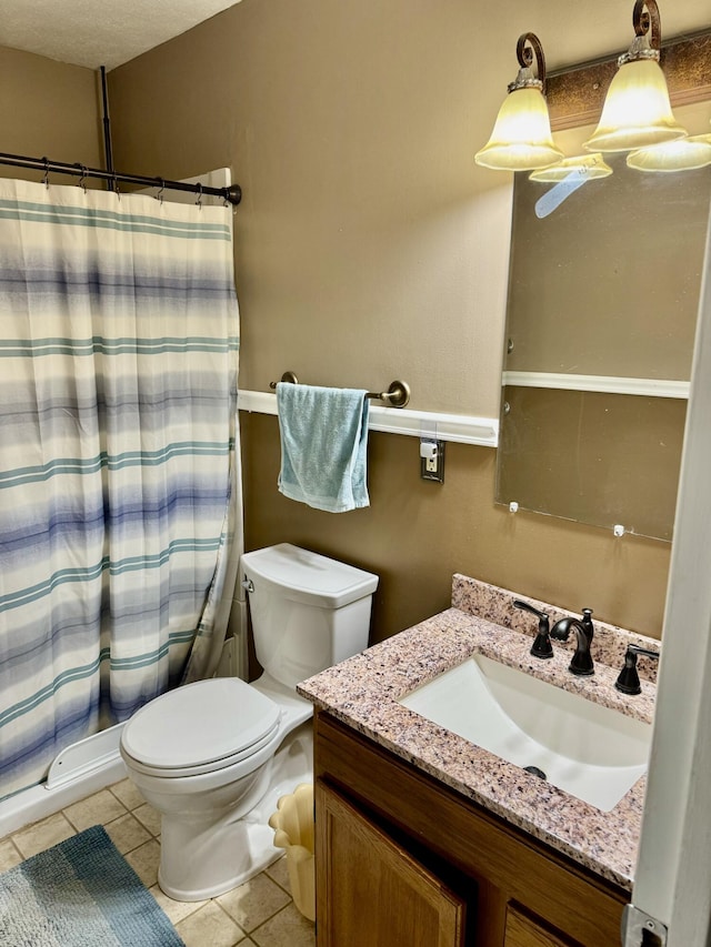 bathroom with vanity, tile patterned floors, toilet, and a shower with curtain