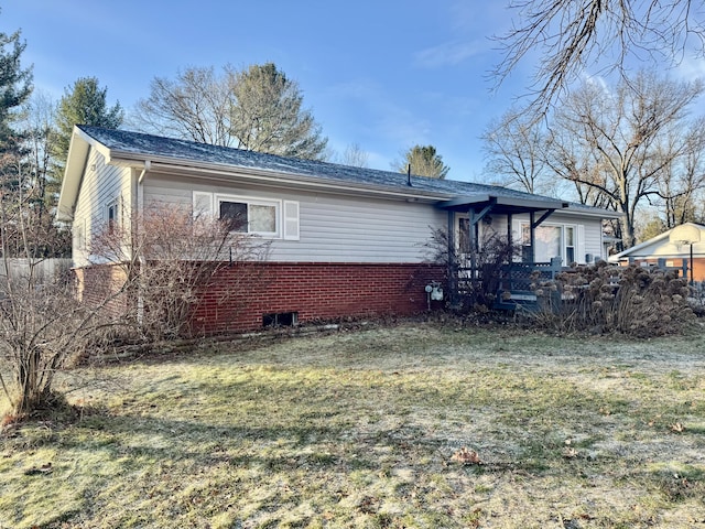 rear view of house with a yard and brick siding