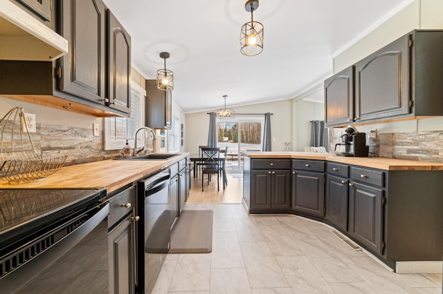 kitchen featuring a sink, under cabinet range hood, stainless steel dishwasher, butcher block counters, and lofted ceiling