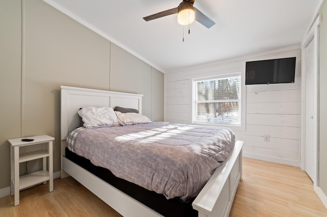 bedroom with light wood-style flooring, a ceiling fan, and lofted ceiling