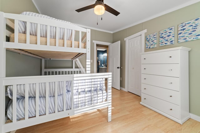 bedroom featuring wood finished floors and baseboards