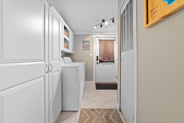 laundry area with rail lighting, independent washer and dryer, and laundry area