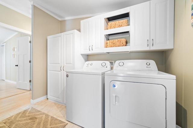 washroom featuring cabinet space and washing machine and clothes dryer