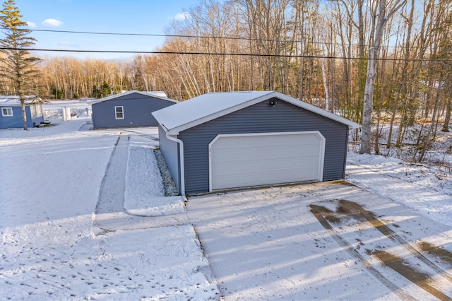 snow covered garage with a garage