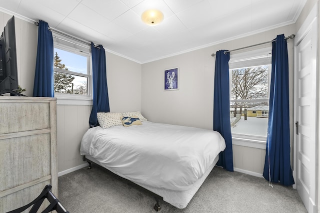 carpeted bedroom featuring baseboards and ornamental molding