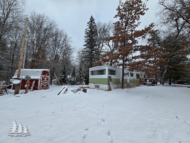 yard covered in snow with an outdoor structure