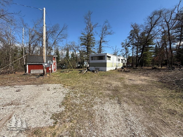 view of yard with an outdoor structure and a sunroom