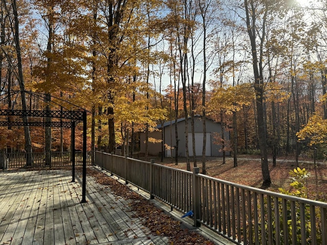 wooden deck featuring a gazebo and an outdoor structure