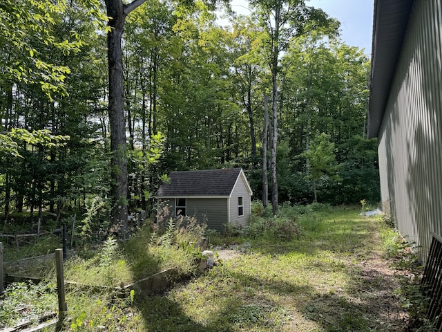 view of yard featuring a storage shed and an outbuilding