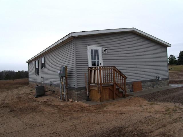 view of side of home featuring cooling unit